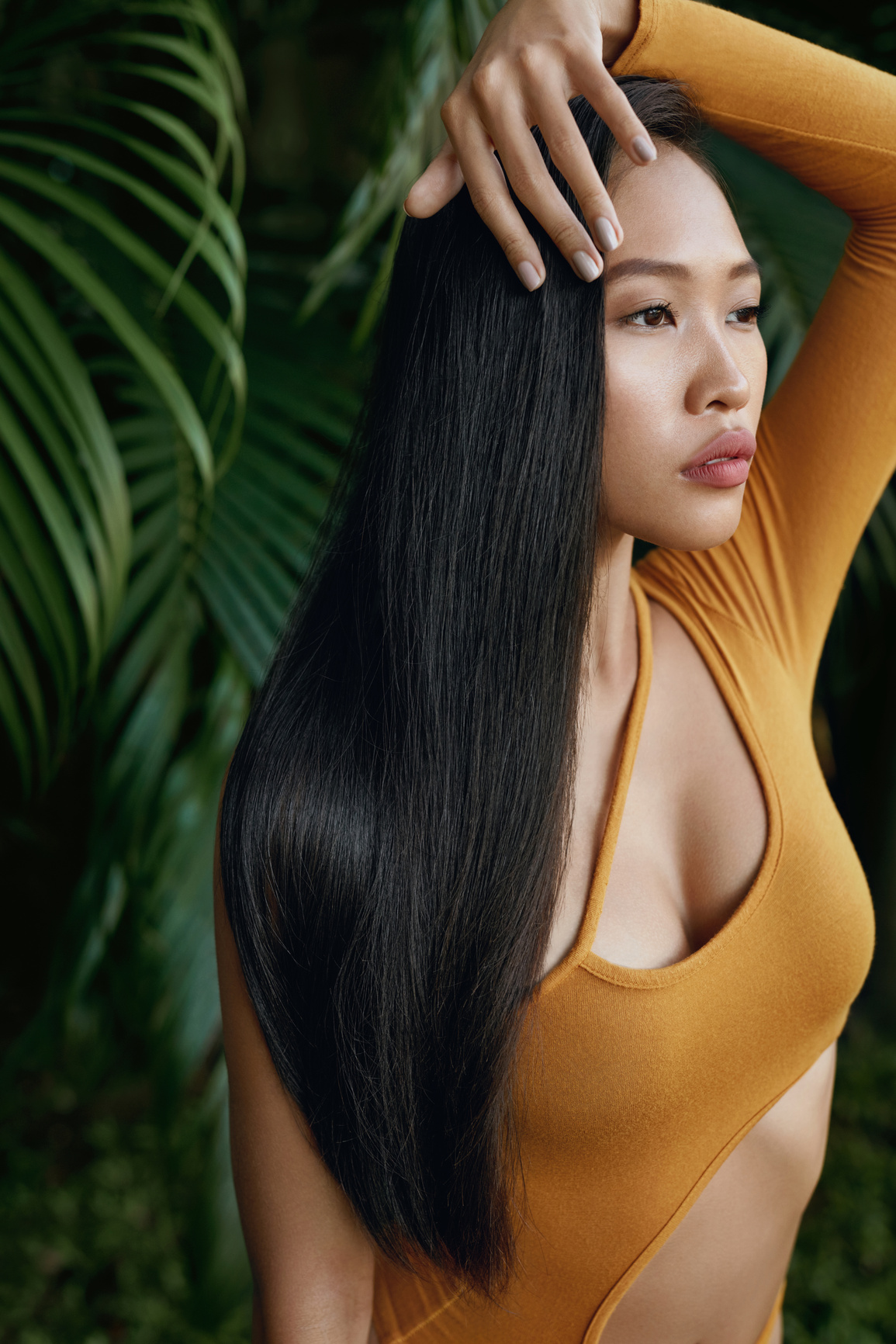 Long hair beauty. Woman with straight hair at tropical nature